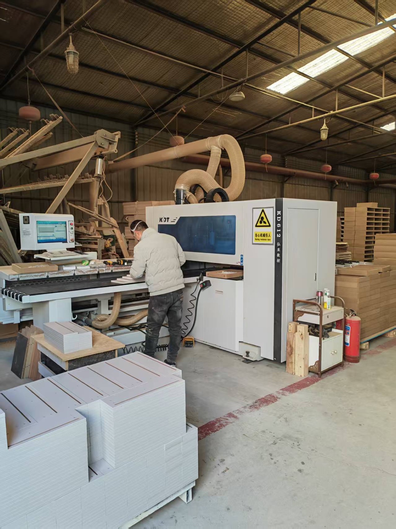 Operator cutting panels on CNC equipment