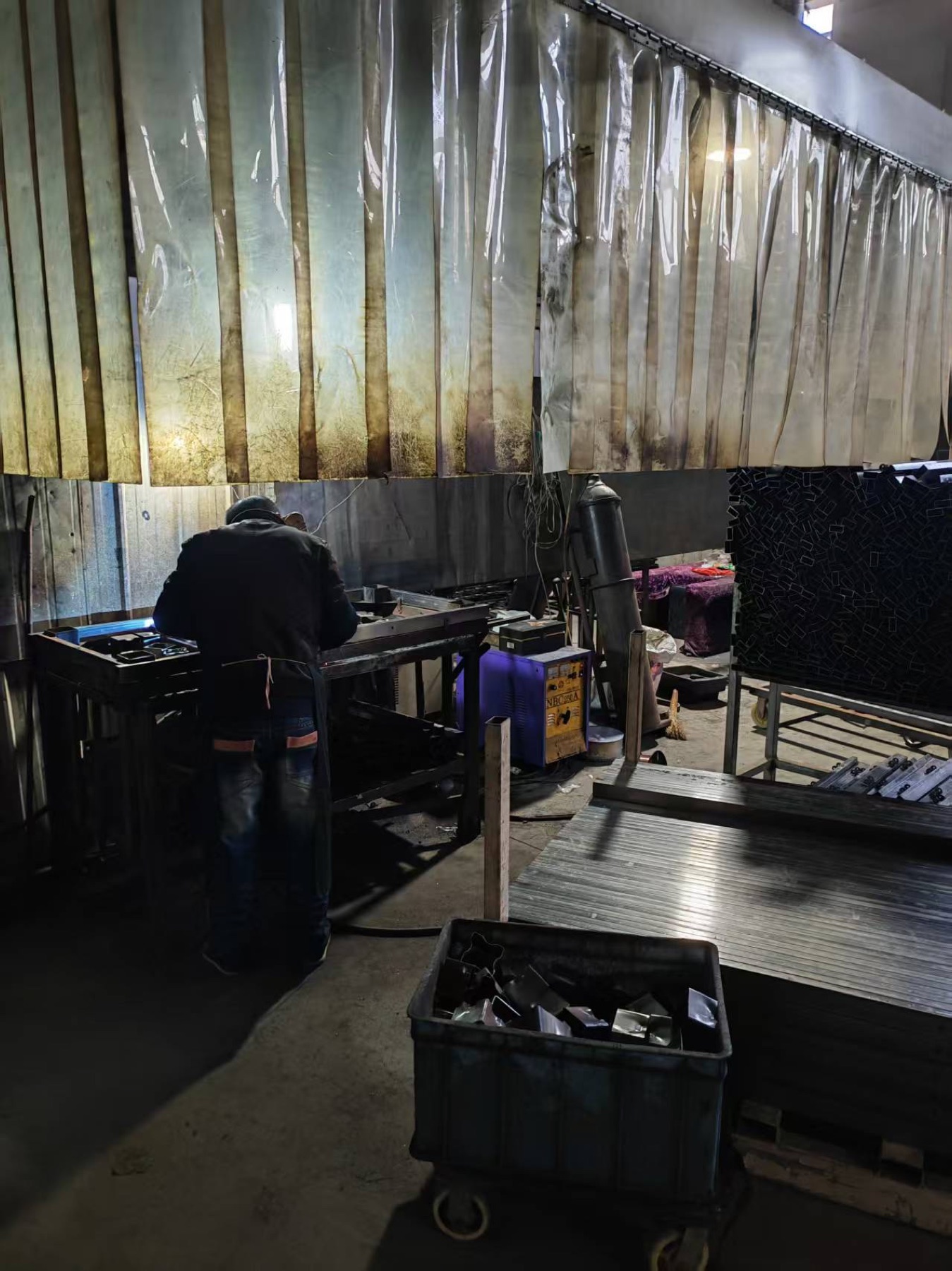 Worker welding metal furniture frames