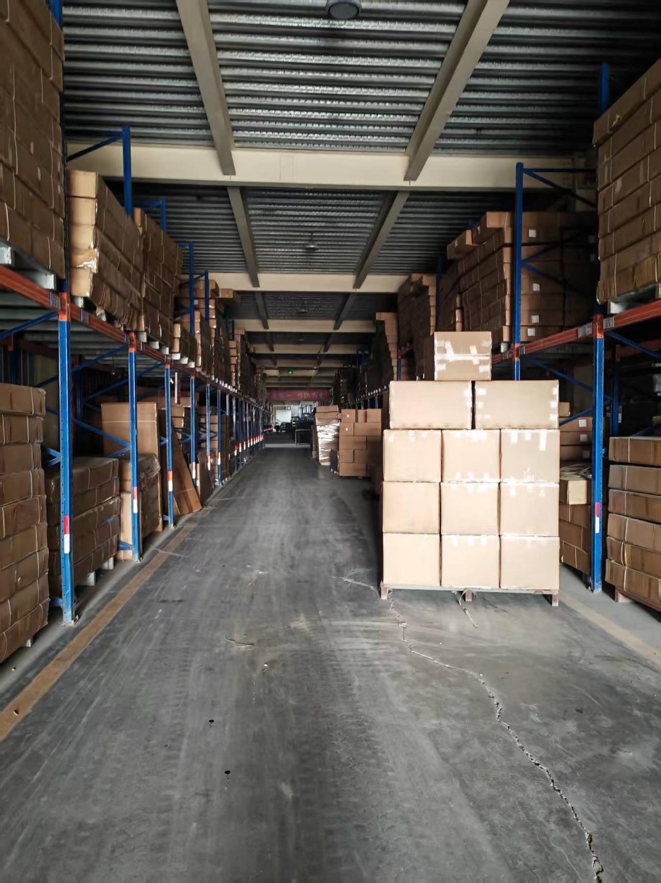Cartons stored along a warehouse aisle