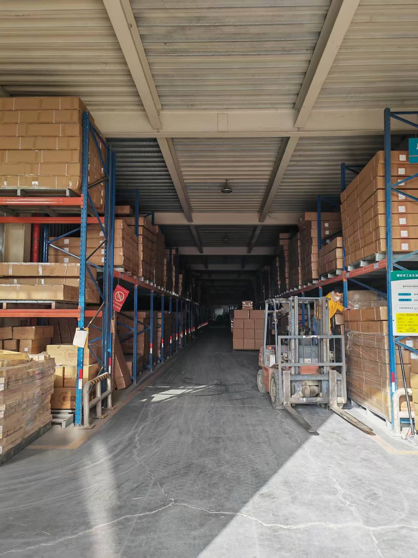Forklift in warehouse aisle